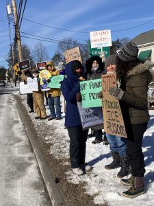 A group of protestors hold signs along rt 117 in Stow