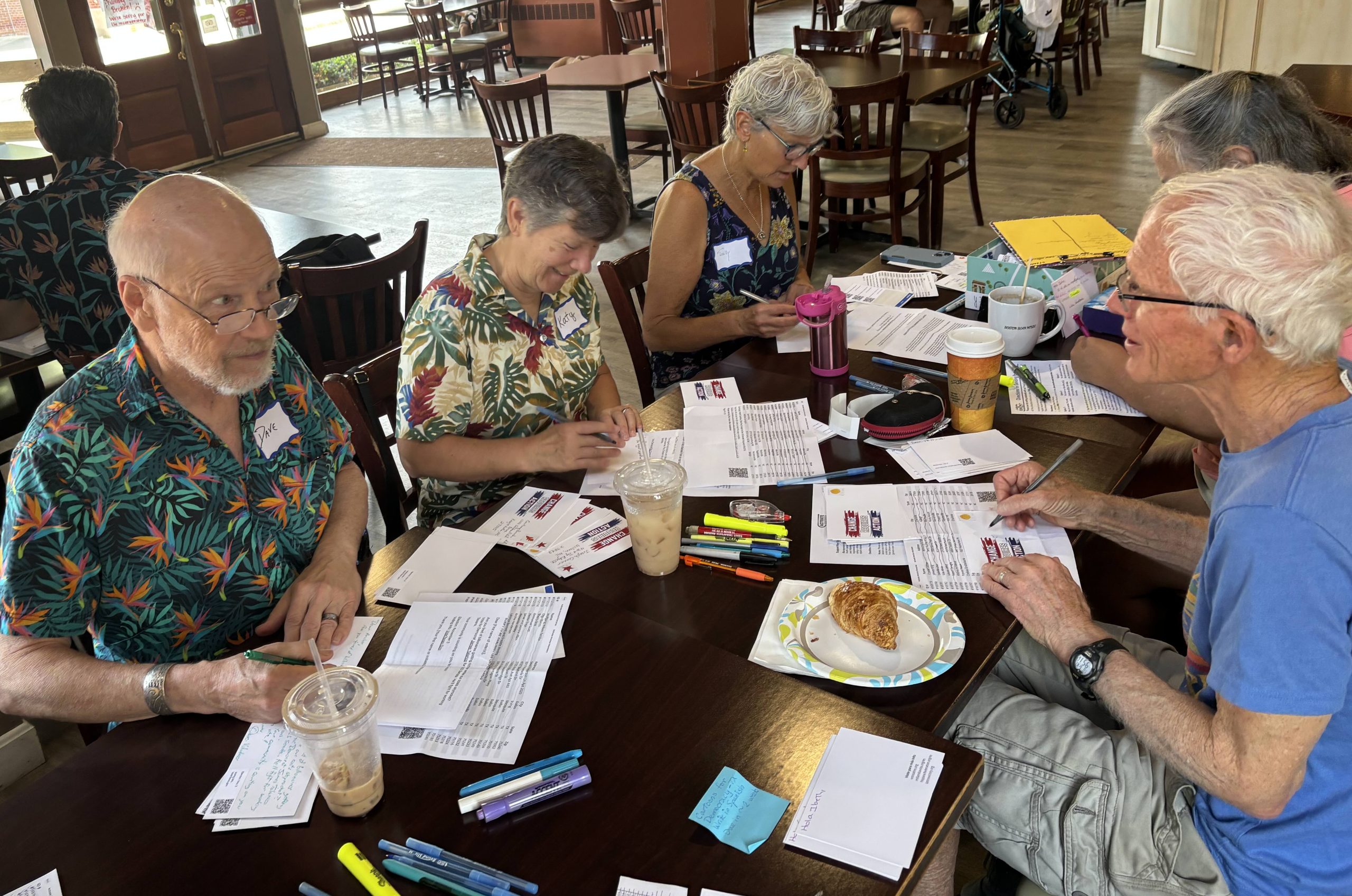 several people writing postcards